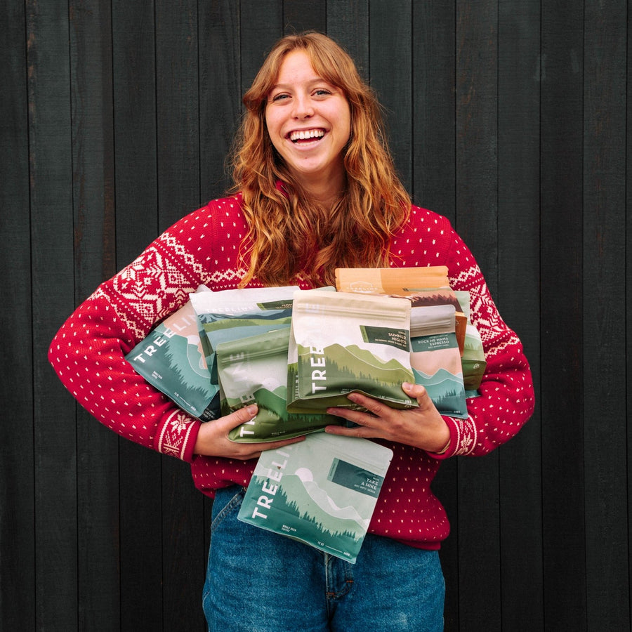 smiling lady holding a bunch of coffee